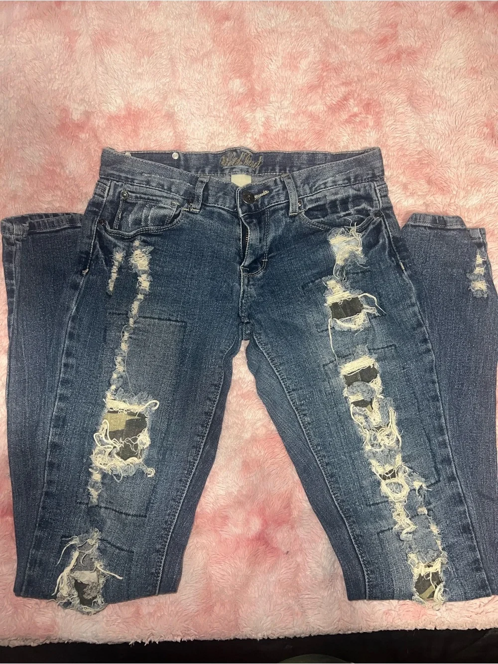 Distressed jeans with camo print
